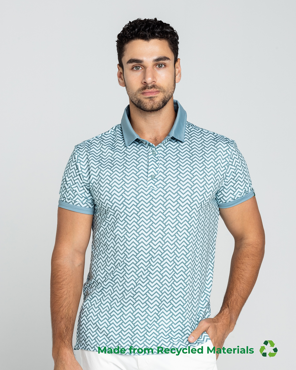 A man wearing a light blue patterned polo shirt with a solid blue collar and sleeve trim, paired with white pants. The design