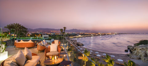 Dusk view from The Edge restaurant at Crowne Plaza Muscat, capturing the best views of the city and beach road in Qurum, by hotel photographer Herbert Fernandes in Oman.