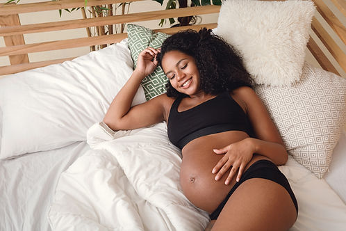 Pregnant woman lay on the bed 