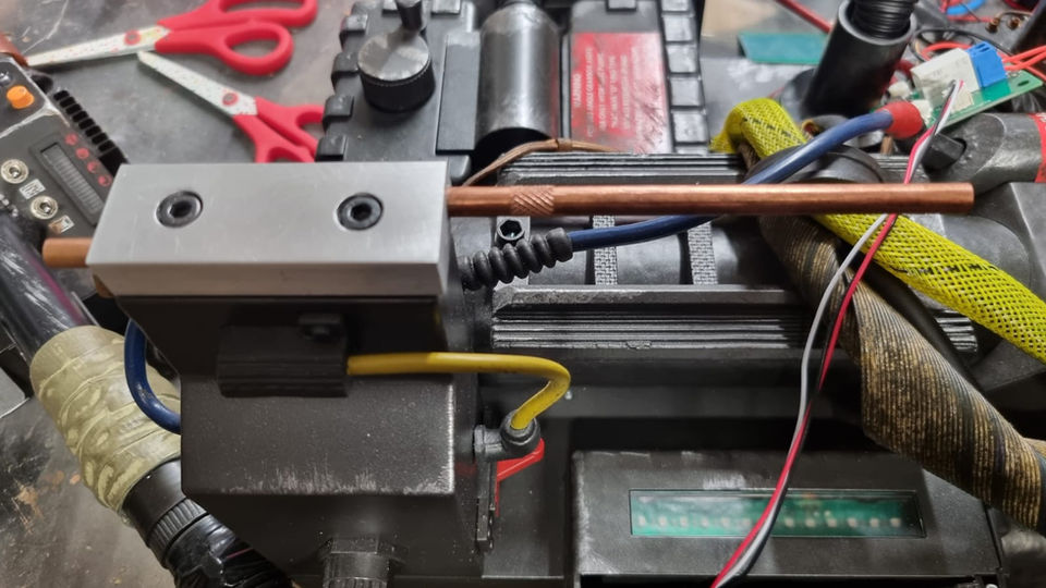 Close-up of a HASLAB Proton Pack Ion Arm End Cap with tools and wires.