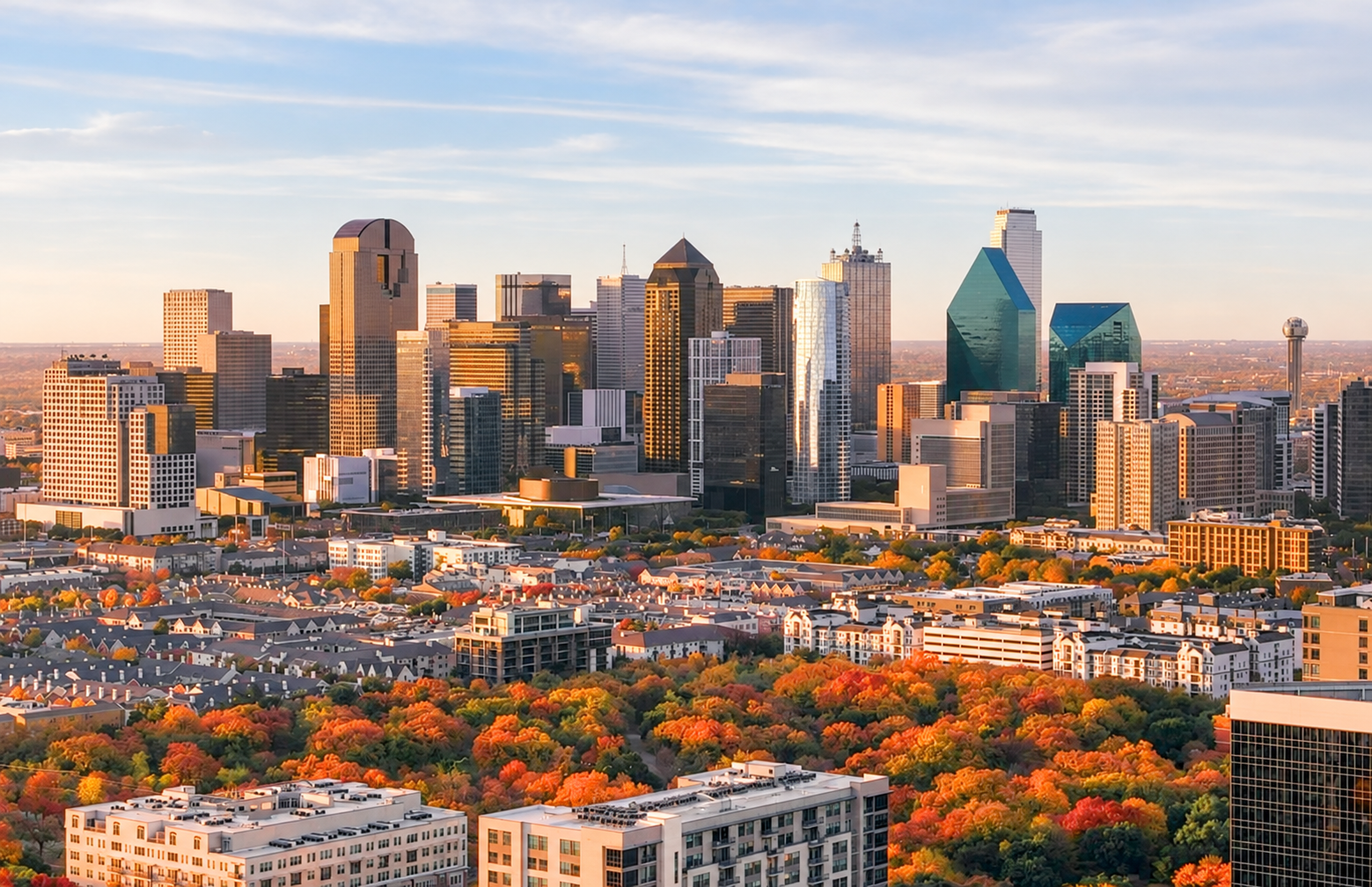Dallas skyline above autumn trees.
