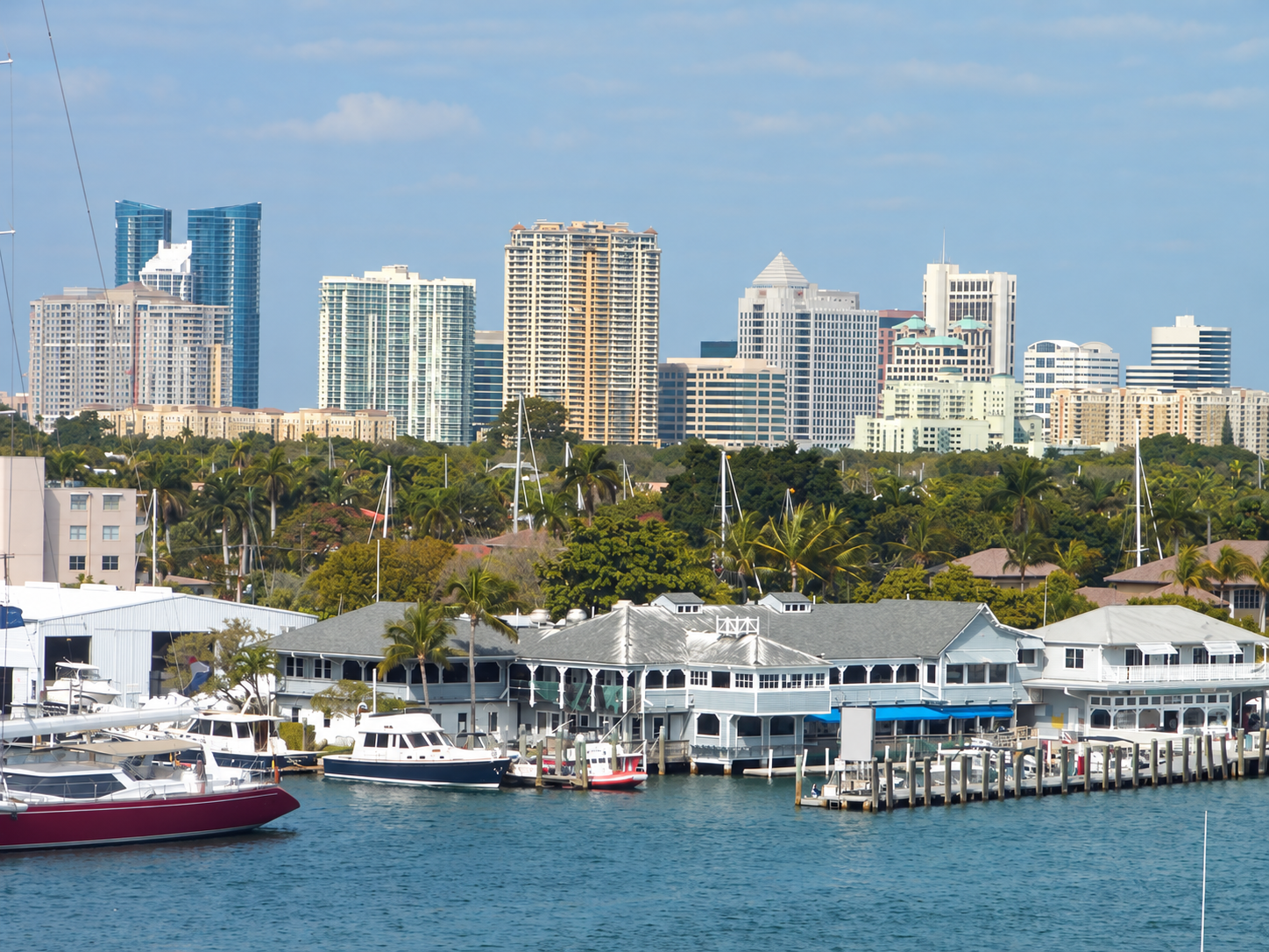 Fort Lauderdale downtown towers above a palm-lined marina and the Intracoastal Waterway.