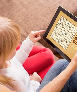 Mother-and-daughter-playing-sudoku-on-tablet-computer.jpeg