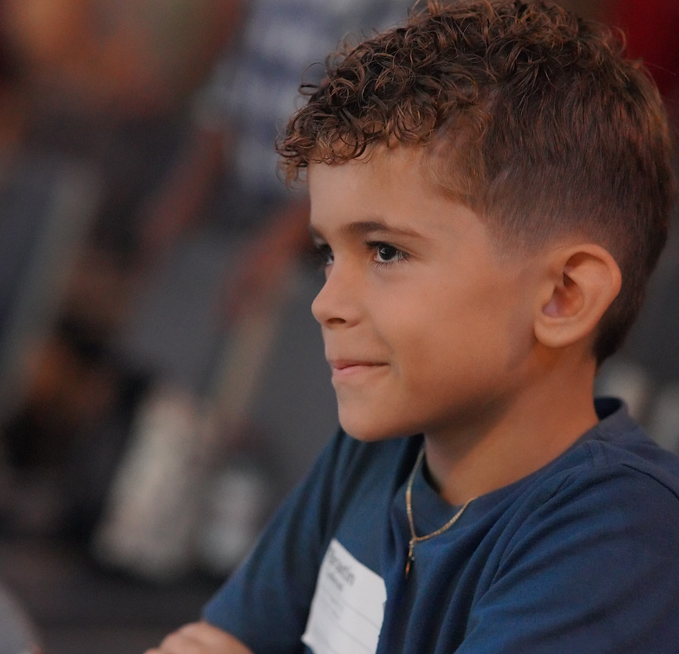 elementary school boy standing in sanctuary watching worship.JPG