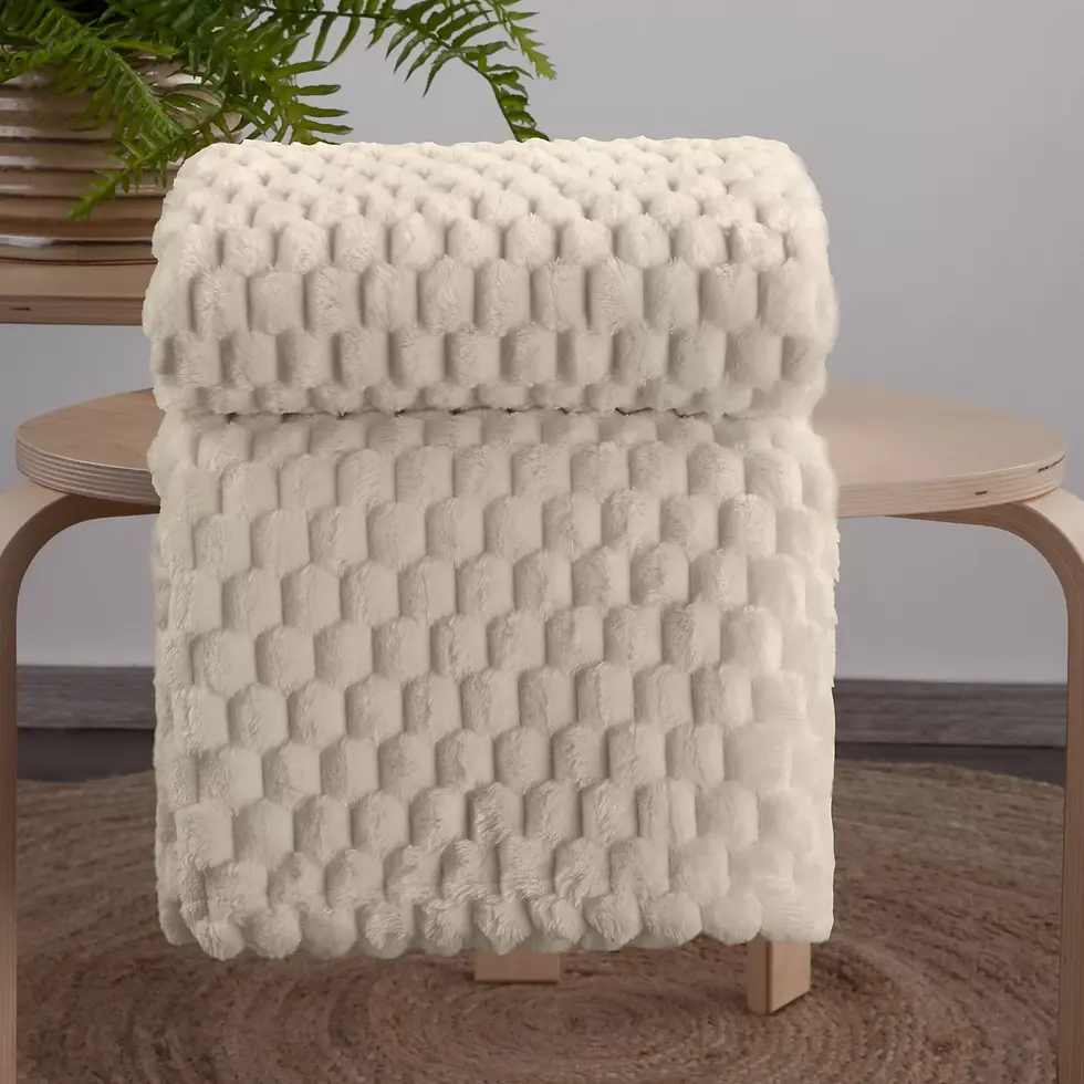 Thumbnail: The beige blanket is very soft to the touch, with a 3D embossed pattern.
