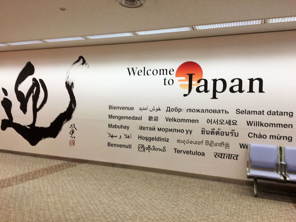 A sign that says "Welcome to Japan" along with different languages of the word, "welcome" on the bottom.
