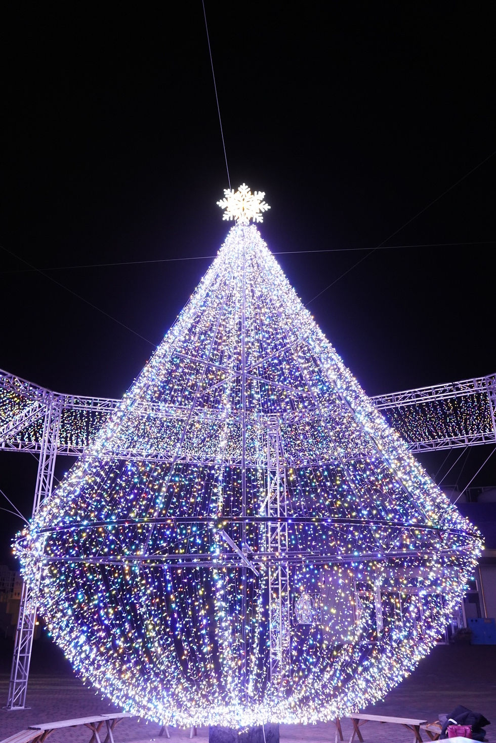 a large light display arranged to look like a Christmas tree with multiple colors and a star on top