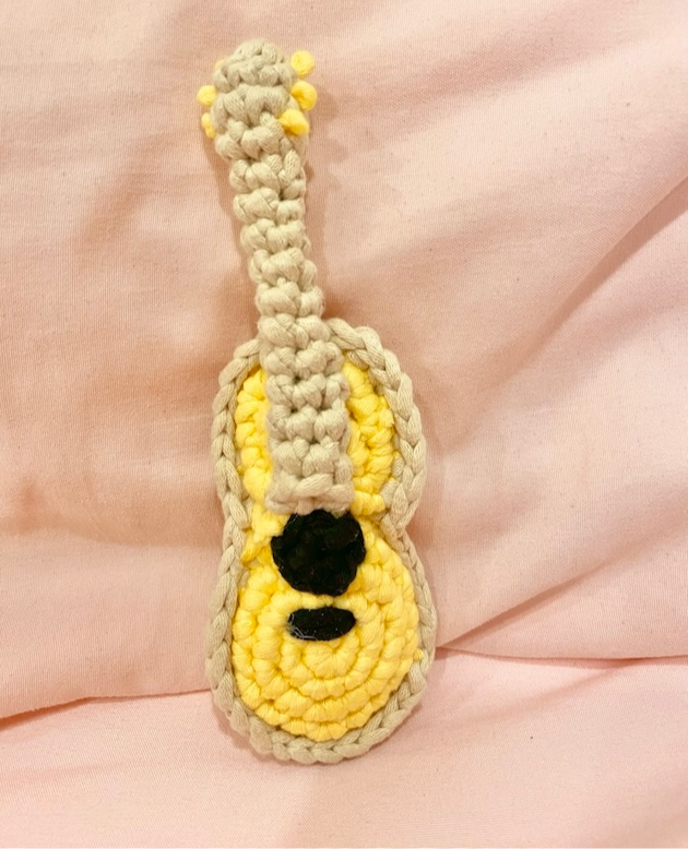 a crochet yellow and brown guitar