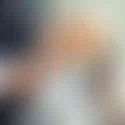 A stunning winter wedding bouquet featuring white roses, pinecones, and seasonal greenery.