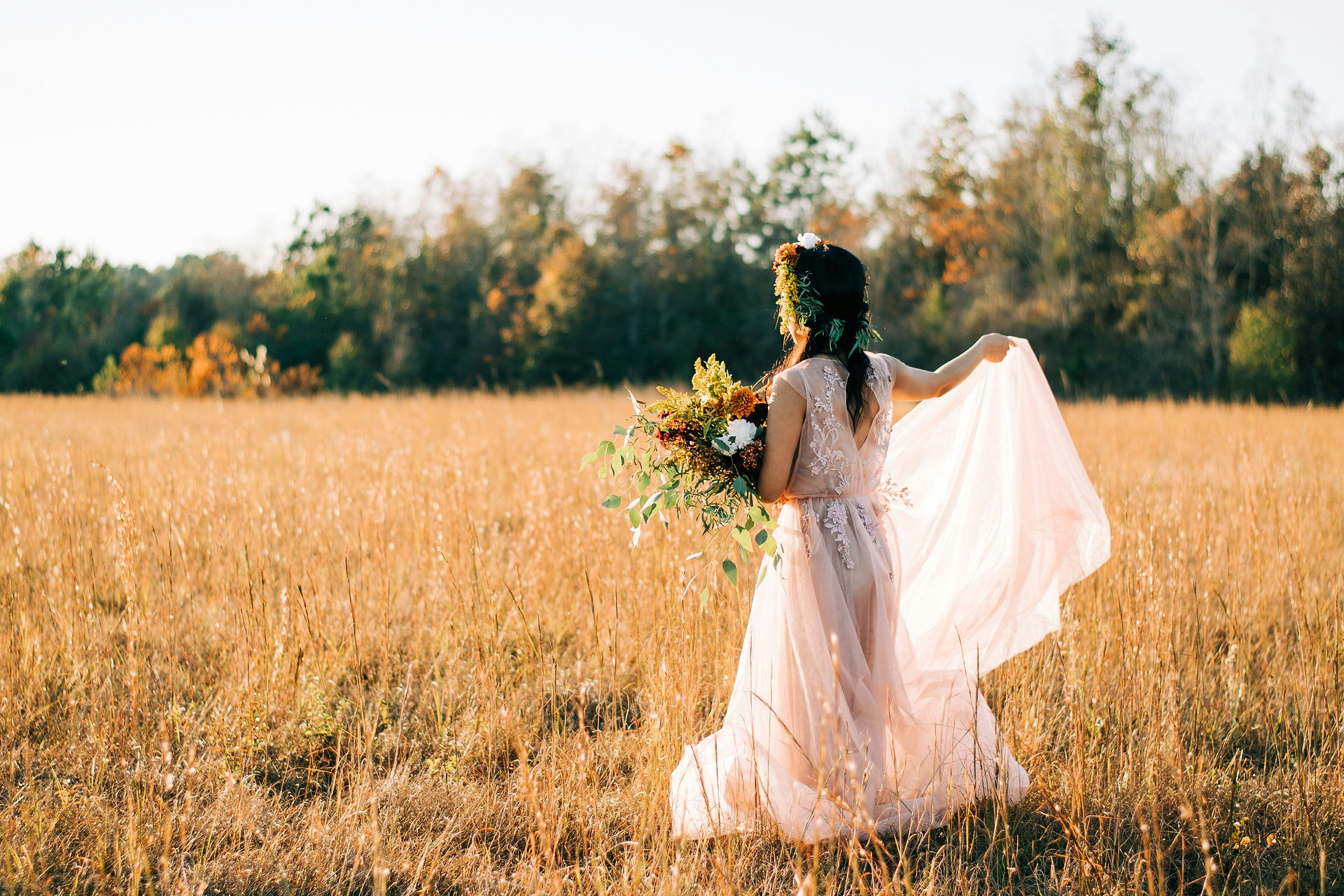 Bride in field during fall.