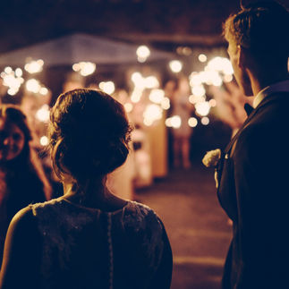 A wedding DJ serving as an emcee, making announcements and engaging the audience at a wedding reception.