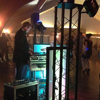 Image of a professional DJ set-up including turntables, mixers, and audio equipment.
