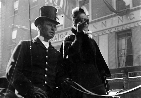 [Man and woman in vehicle passing 102-103 Grafton Street] c.1897-1904 NLI.png