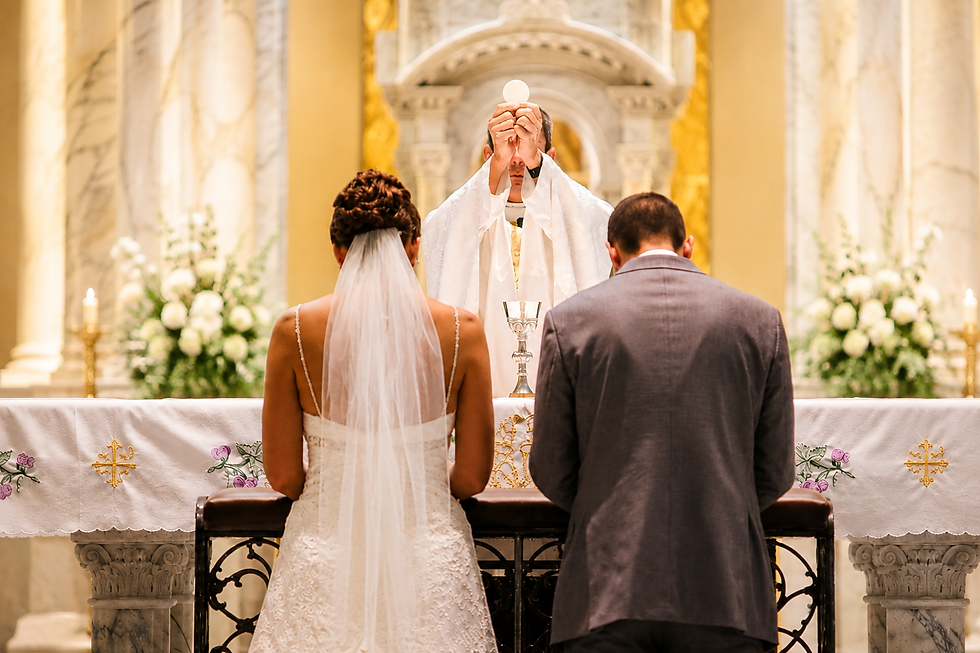 A couple at the Liturgy of the Eucharist during the Nuptial mass within the Catholic wedding ceremony