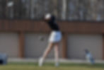 Isabella Portokalis swinging gold club on golf course.