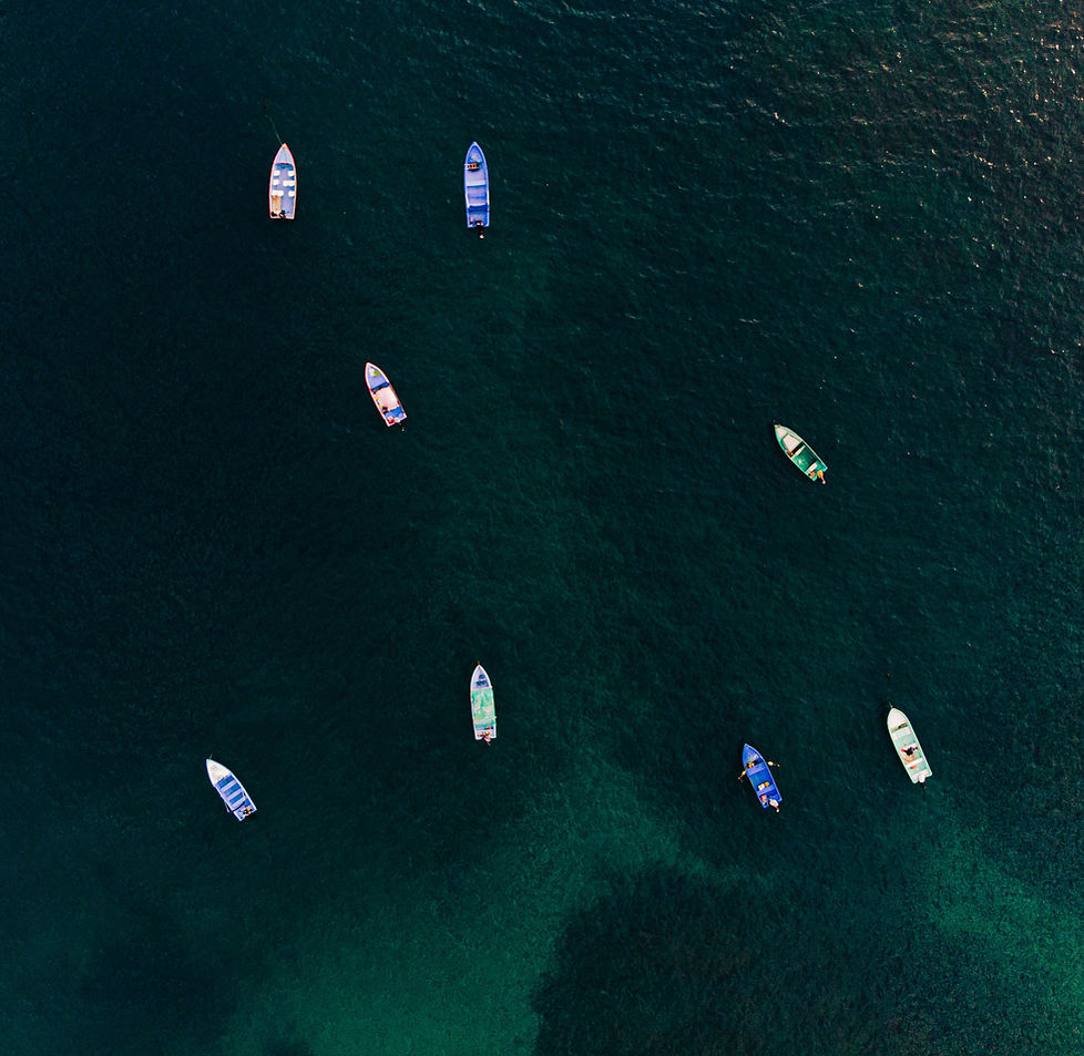 aerial-view-of-sailboats-drifting-in-a-crystal-cle-2023-11-27-04-51-41-utc.jpg