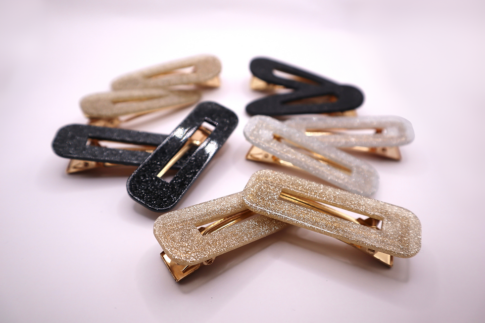 gold, silver, and black barrette clip