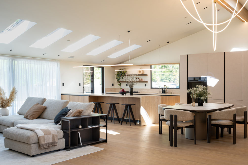 Open concept living and kitchen in Woodland Hills renovation with skylights, custom millwork, interior design and built-in furniture