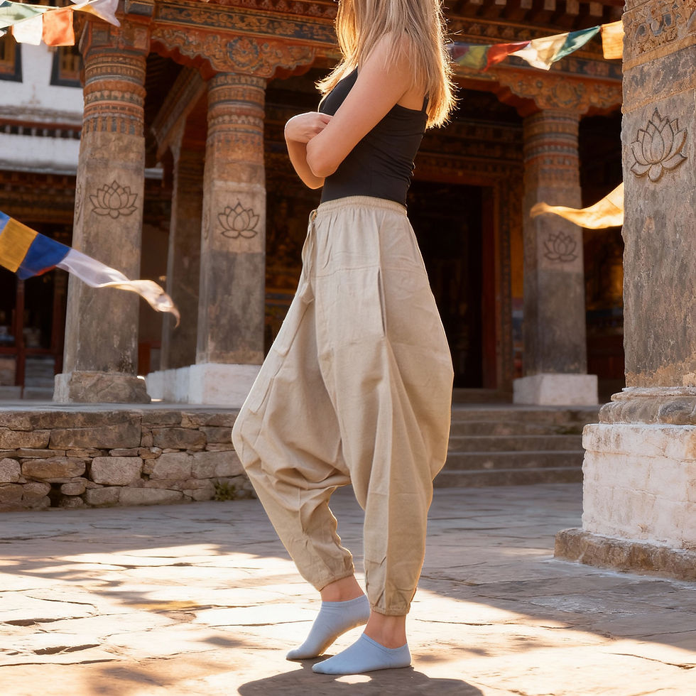 Thumbnail: Side profile of a woman posing with arms crossed in loose beige Aladdin trousers.