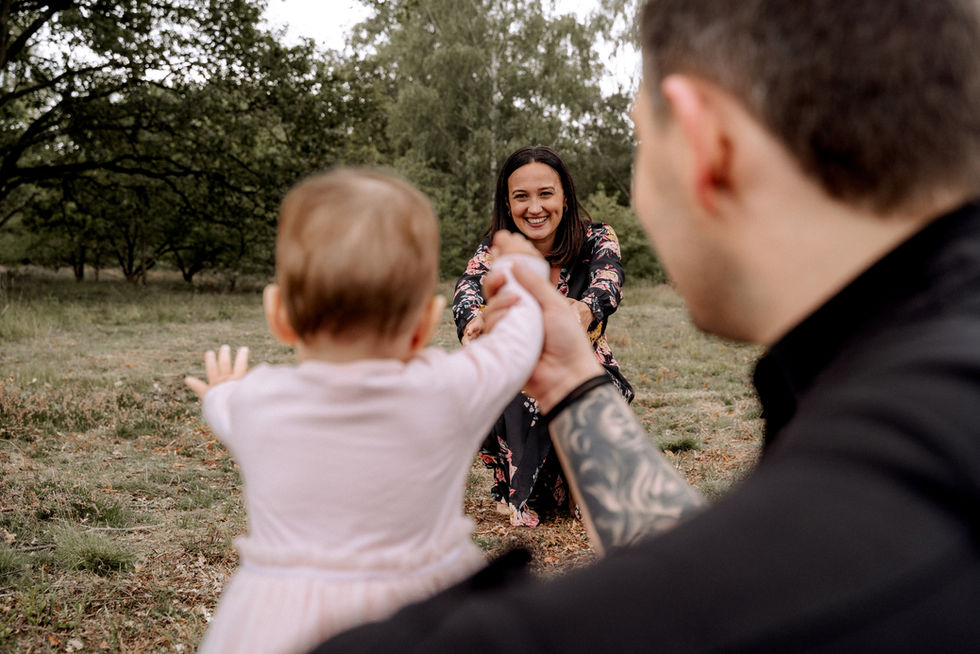 Fotoshooting in der Nähe von Syke. Familie auf einem Feld. Tochter läut zu Mama.