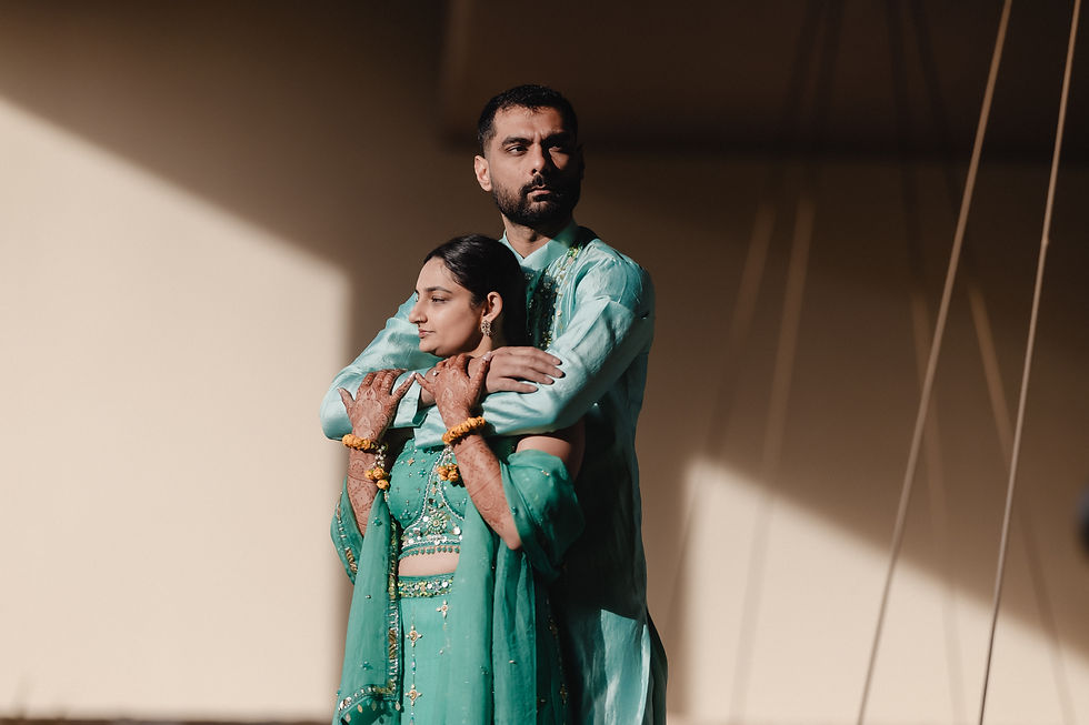 Indian couple in green Haldi outfits sharing an intimate moment under natural light at Hard Rock Los Cabos