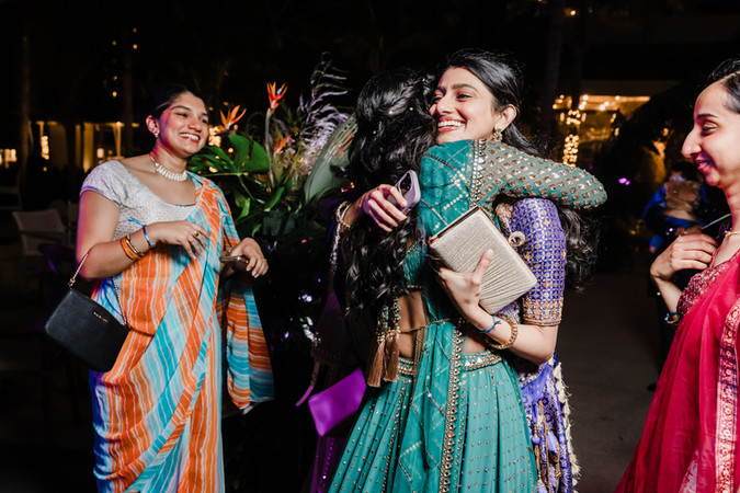 Guests in colorful sarees laughing and enjoying the Sangeet night at Garza Blanca Cancun