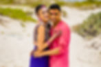 Bride and groom covered in turmeric smile joyfully during their Haldi ceremony on the beach at Hilton Cancun.
