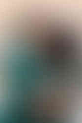 Groom in an emerald green sherwani embracing his bride in a matching green outfit during their Indian destination wedding at Garza Blanca Cancun.