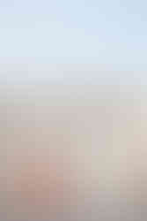 Indian bride and groom share a joyful embrace, her red saree flowing in the breeze at Garza Blanca Cancun
