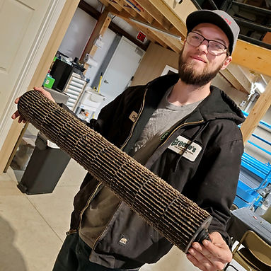 HVAC Technician Pulls Dirty Furnace Filter During Furnace Maintenance in Tiffin, Ohio