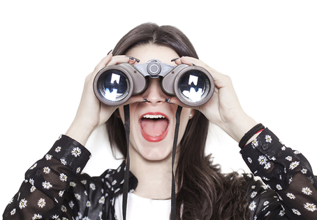 A women looking through binoculars for career spark to reignite her process and fulfillment.