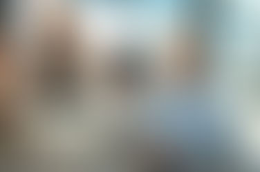 Photo or an older female professional in an office with young people conveying how aging workers can maintain relevance.