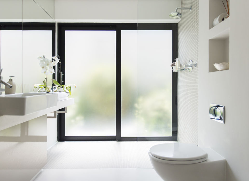 Bathroom window with 3M Fasara Window Film installed. 