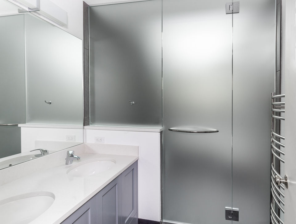 Glass shower door with 3M Fasara Window Film installed. 