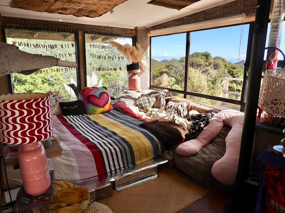 Open plan lounge with large windows looking into nature, Soul Thing retreat for sale New Zealand