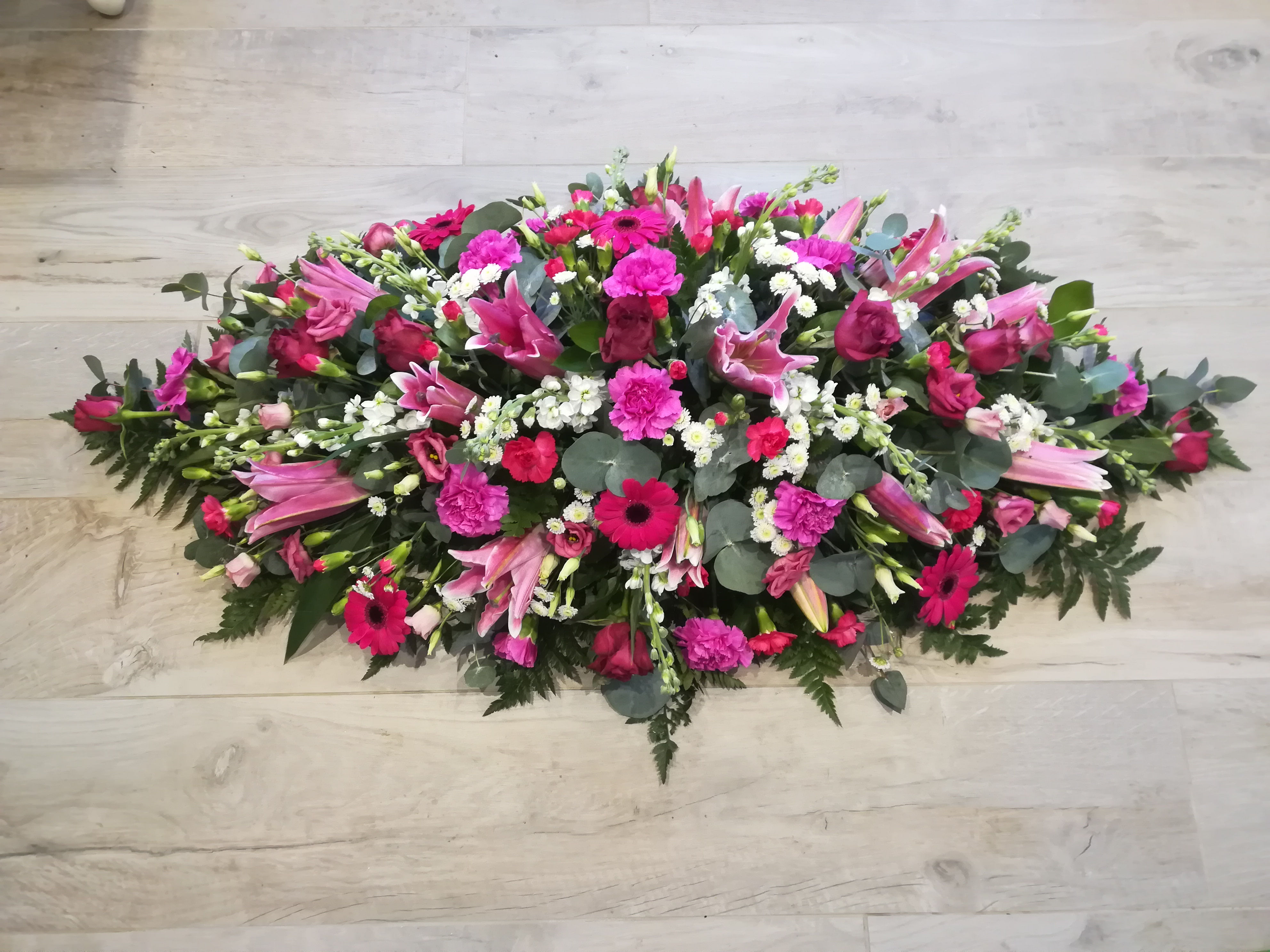 Cerise pink and white casket flower arrangement