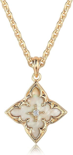 Gold chain with a clover-shaped pendant featuring a pearl-like center and a small diamond. Elegant design with a reflective surface.