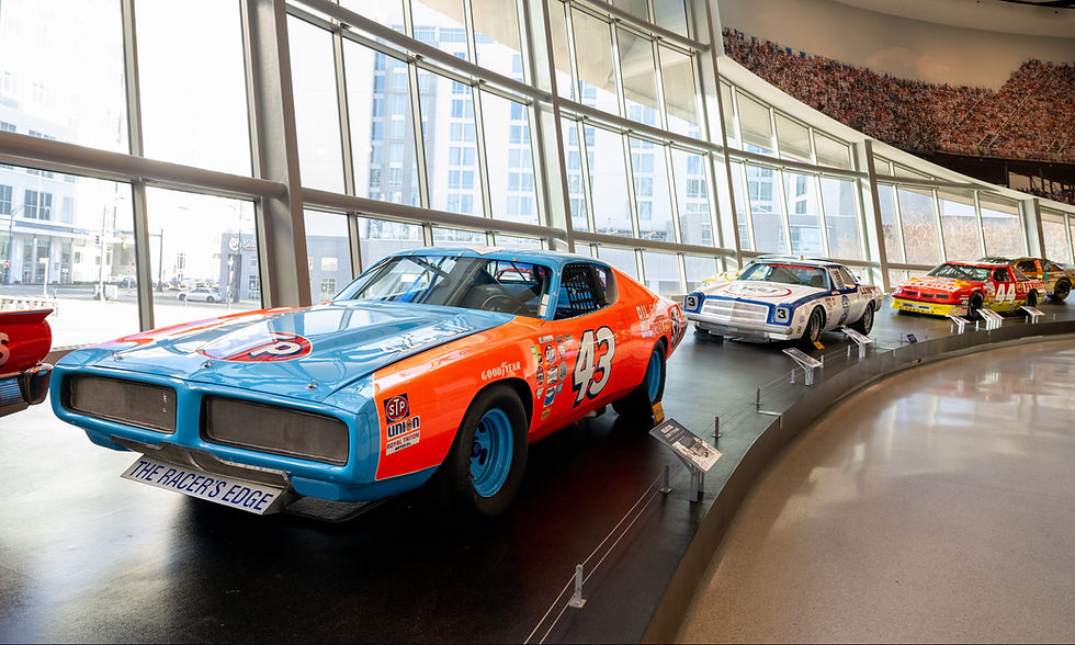 The Glory Road exhibit showcases iconic NASCAR cars from different eras.