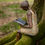 Thumbnail: large seated girl sculpture reading 