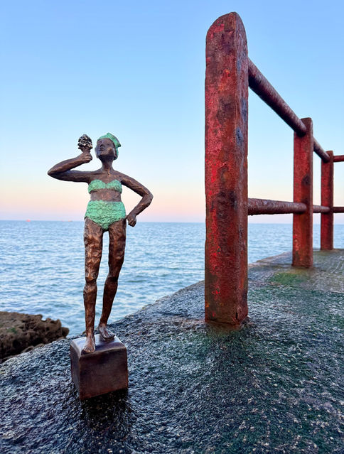 Sculpture girl swimming with ice cream