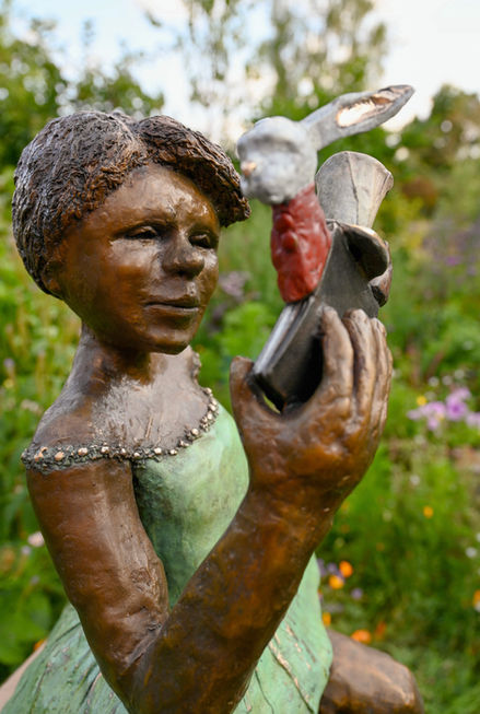sculpture statue of Alice in wonderland with figures 