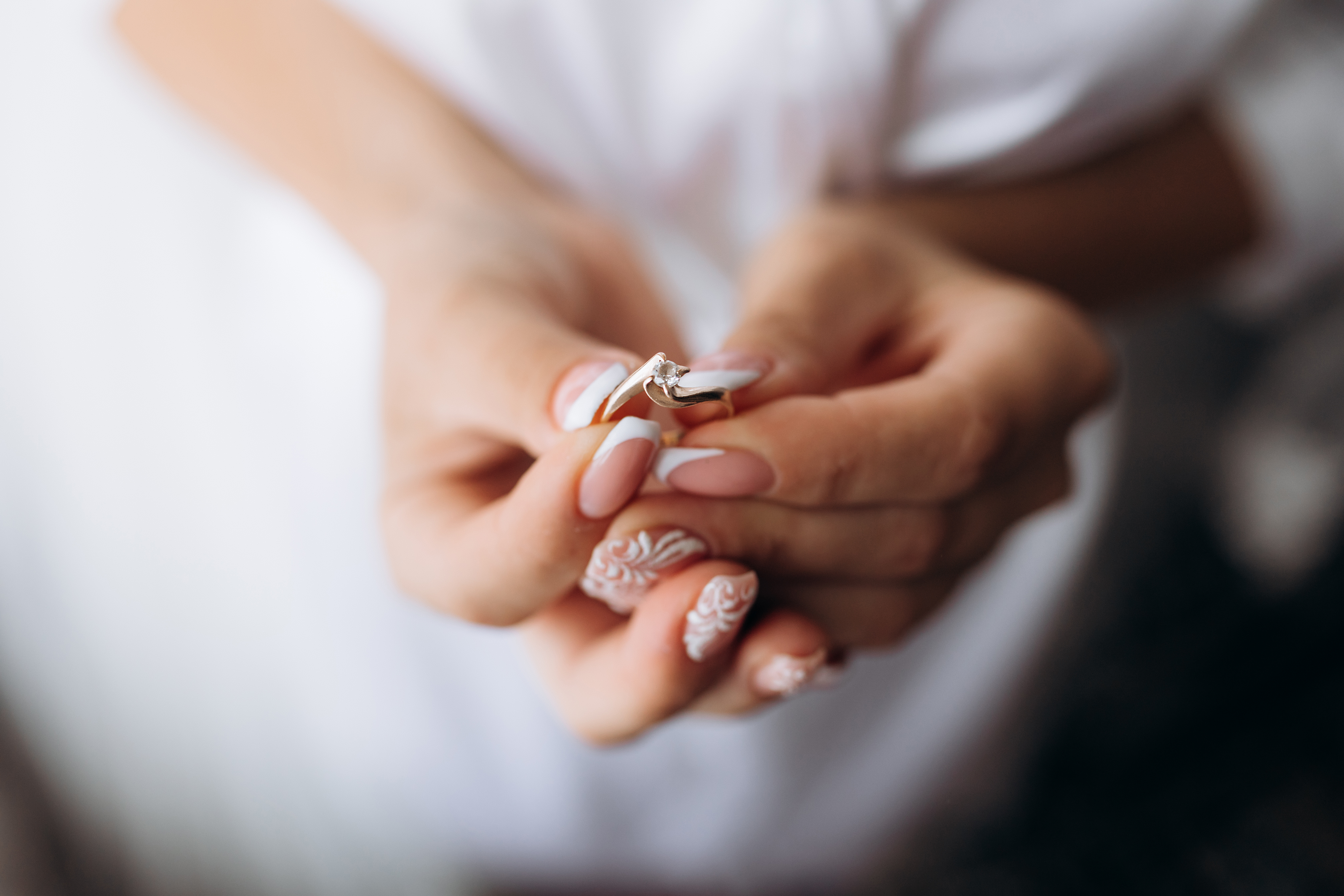 A woman holding her hands showing off an elegant and professional manicure.