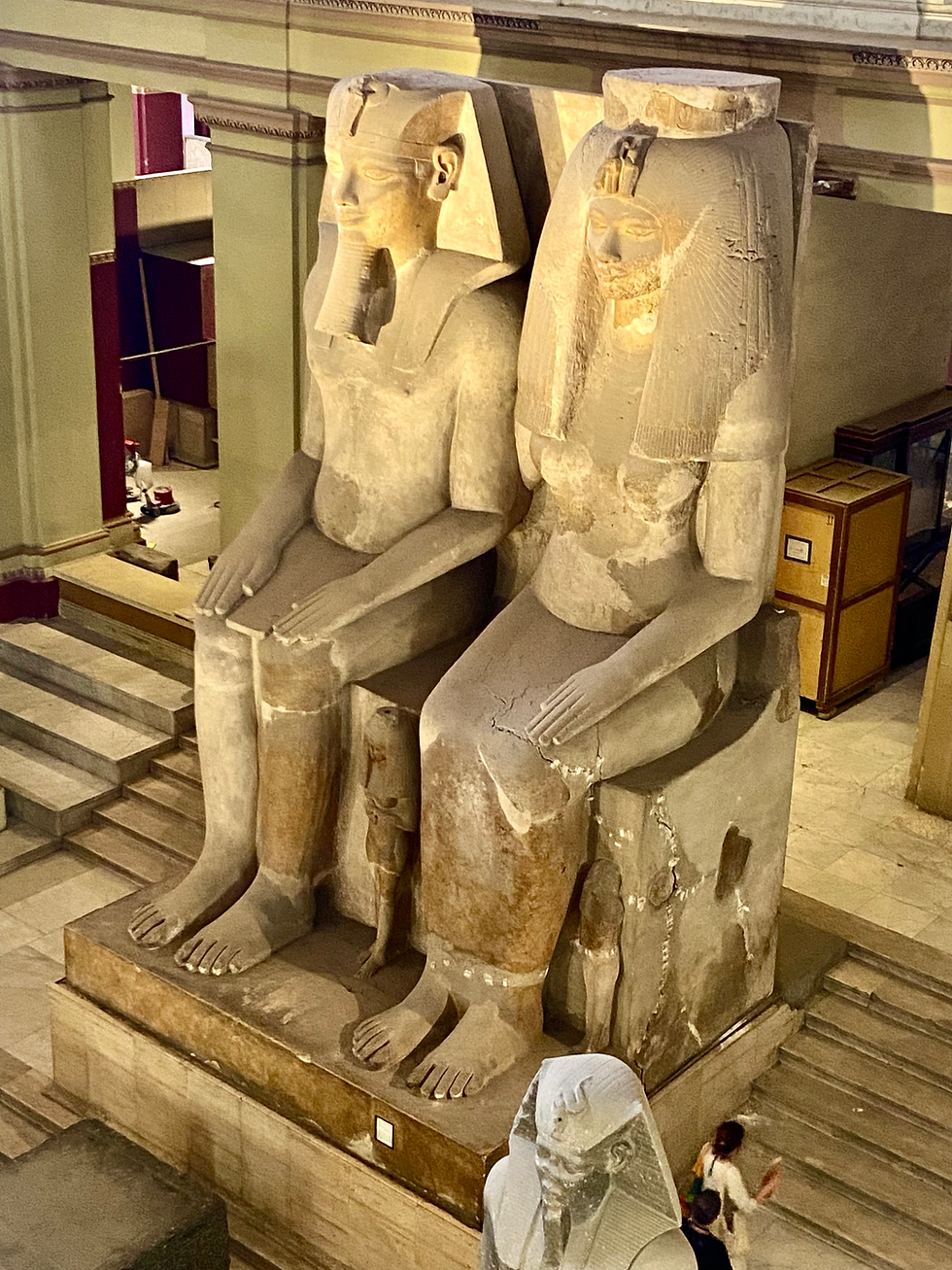 massive, 7-meter-tall (23 ft) limestone monolith group statue located in the central hall of the Egyptian Museum in Cairo, depicting the Pharaoh Amenhotep III and his wife, Tiye.
