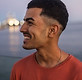 smiling-man-in-front-of-a-city-building-2026-09-25-01-10-19-utc Pequena.jpeg