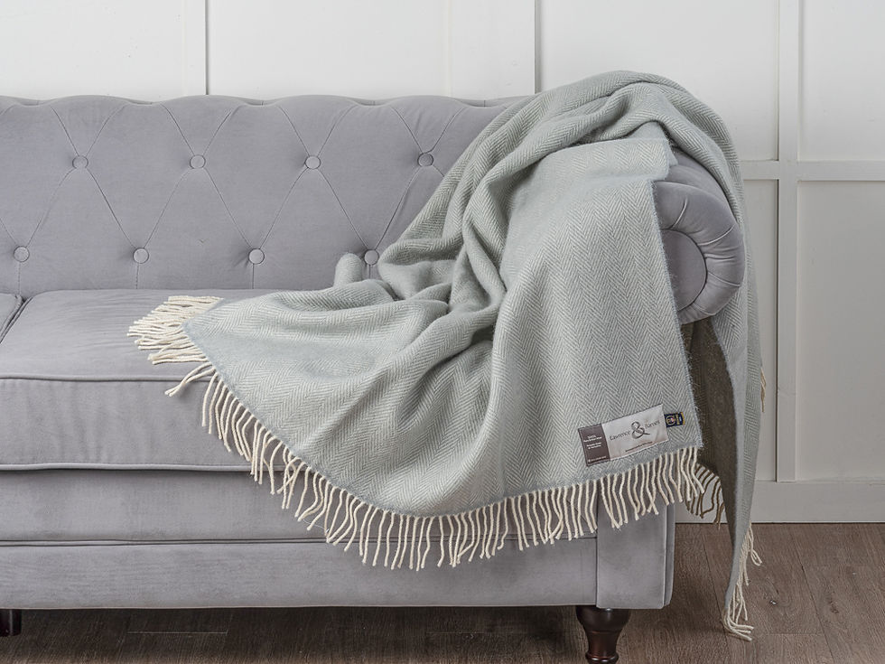 Thumbnail: The Thistle Grey Richmond woollen throw elegantly draped on a grey velvet sofa - 100% British worsted wool