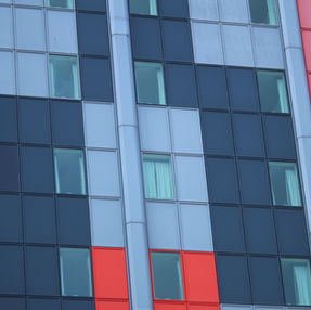 Front view of hotel building with coloured cladding
