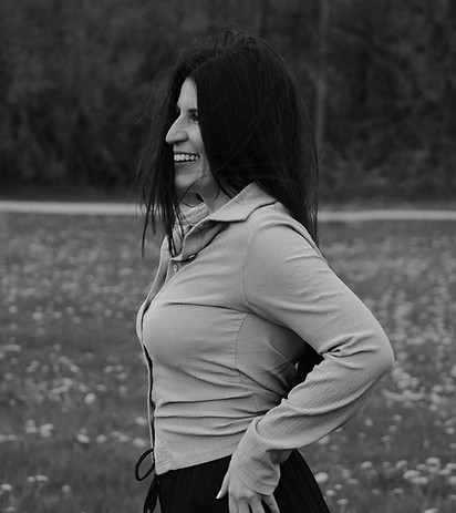 Smiling woman outdoors representing grounded manifestation, clarity, and intuitive guidance