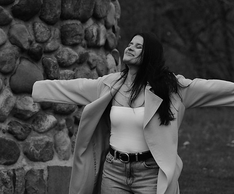 Woman with open arms representing emotional freedom, clarity, and spiritual connection