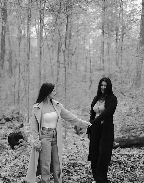 Two women in a forest representing intuitive guidance, spiritual connection, and grounded support