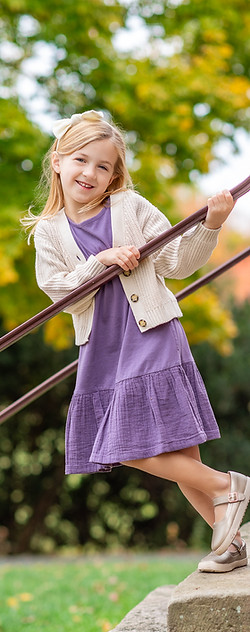 Girl in purple dress on stairs